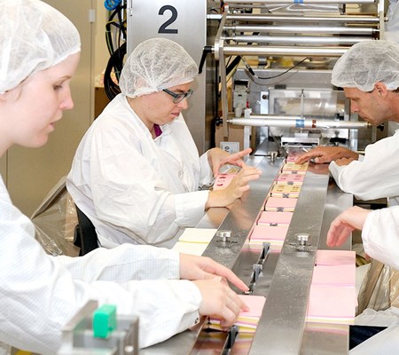 Employees packaging candy paper